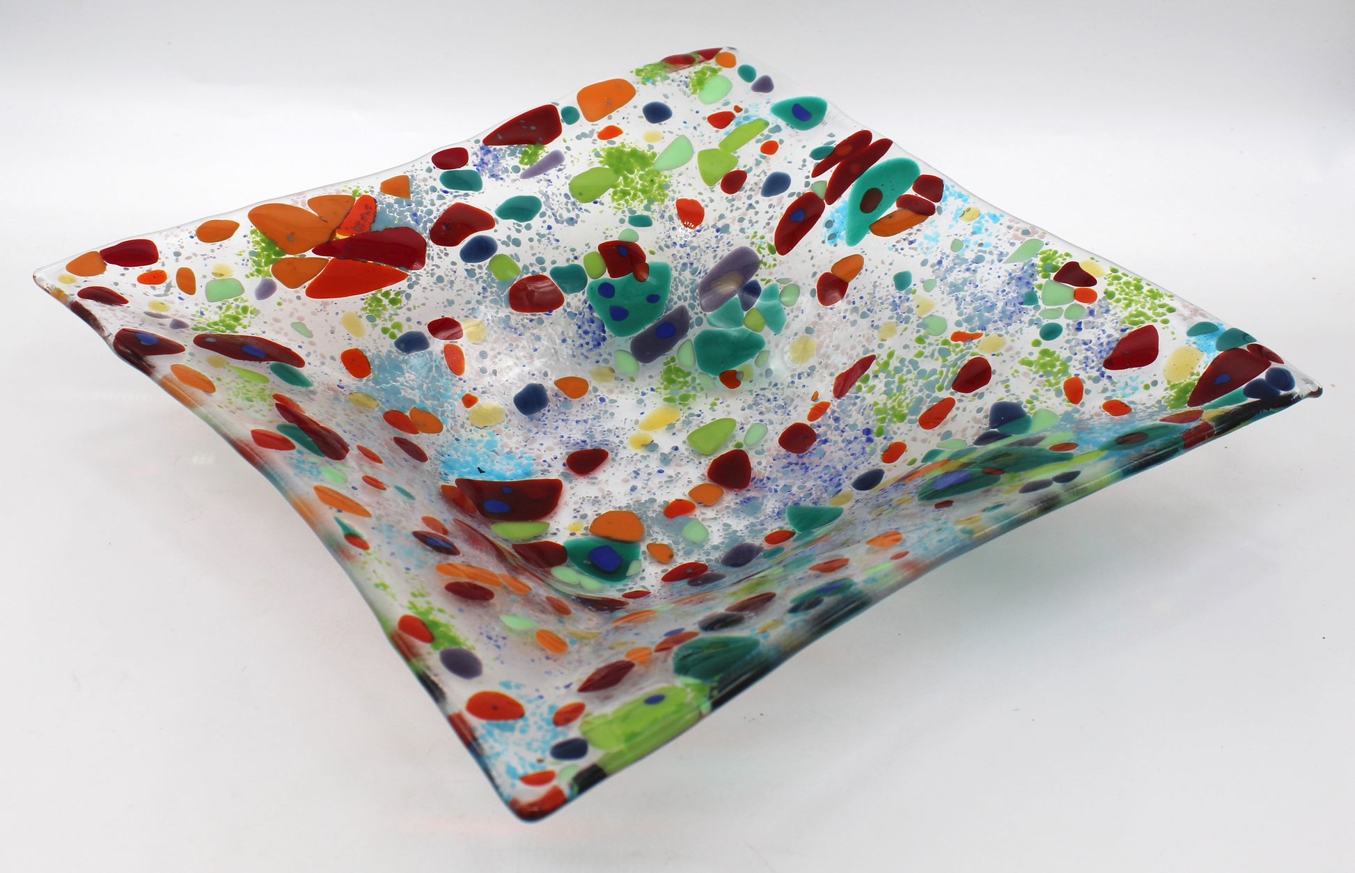 clear glass square bowl withe spots of red and greens, with specks of blue