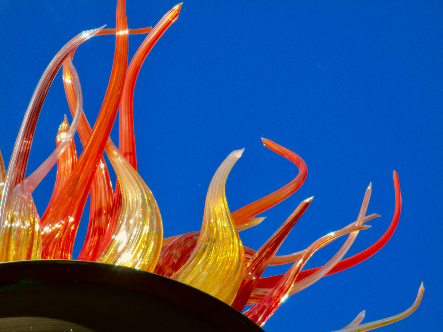 This is a photo of a blue background with red and yellow fiery glass coming out.