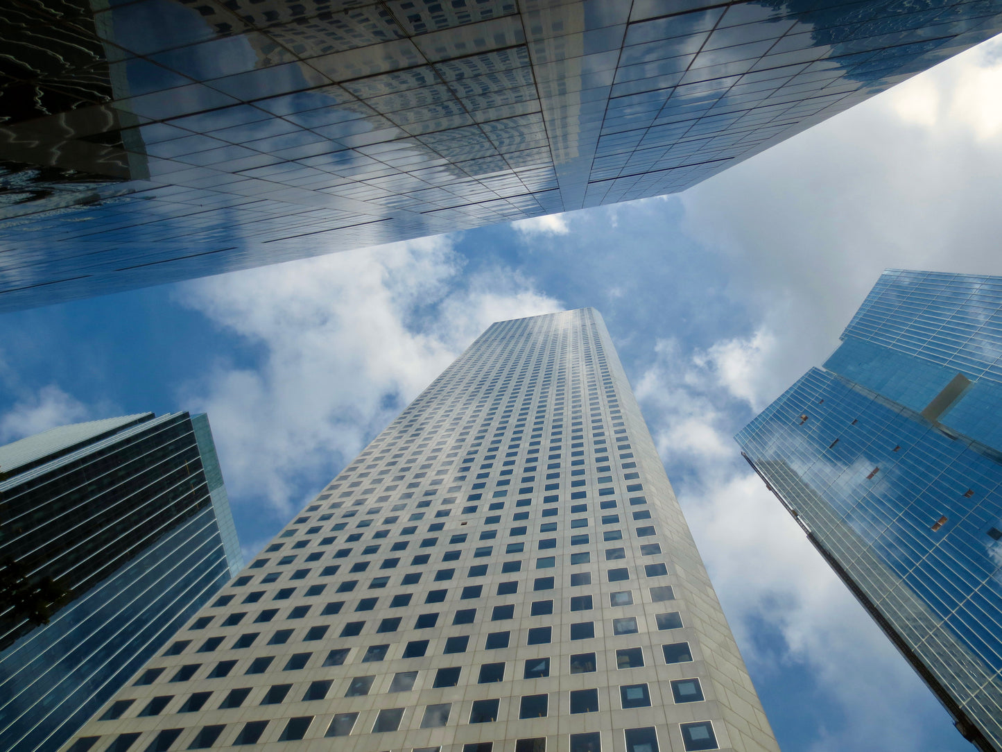 This is a photo of skyscrapers taken from below against a blue sky