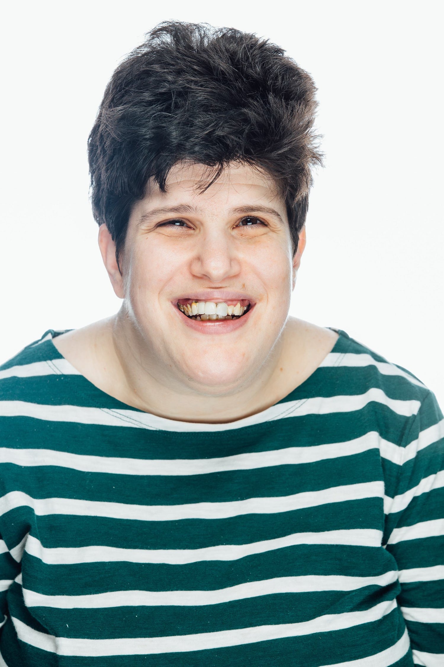 Smiling woman with brown hair and green and white striped shirt