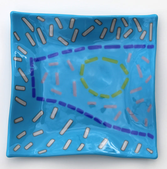 blue wavy plate with short lines broken up to form shapes