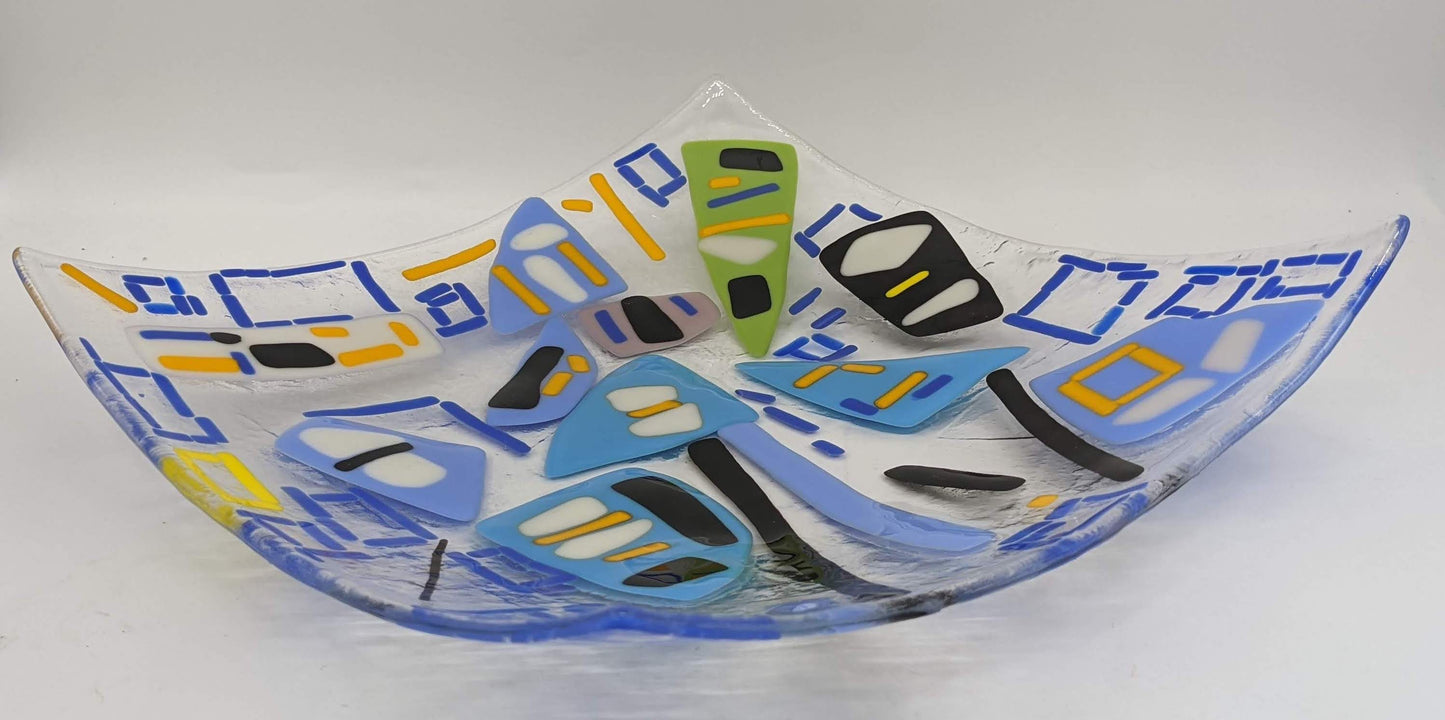 clear glass plate with blue squares with white and yellow spots