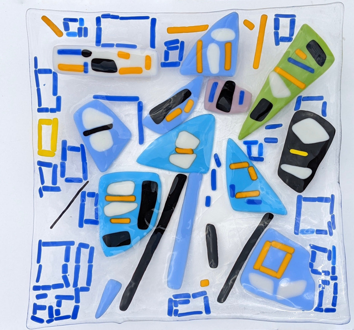 clear glass plate with blue squares with white and yellow spots
