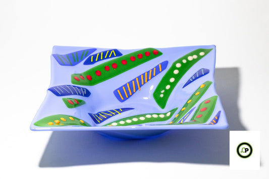 glass bowl with sections of green and blue with dots and lines on top