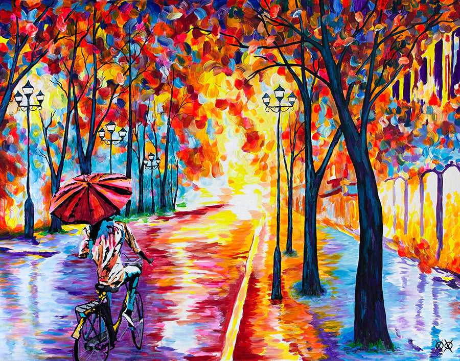 person on bike riding down an avenue