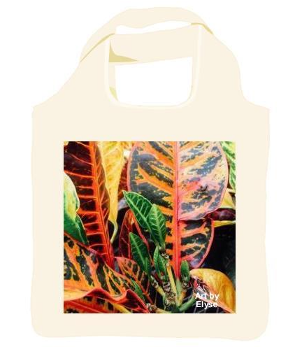 Reusable shopping tote with an image of a Photograph of a close up of green leaves sprouting in the center of the plant, surrounded by larger leaves with red veins