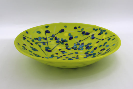 green bowl with blues speckled around with a few lines