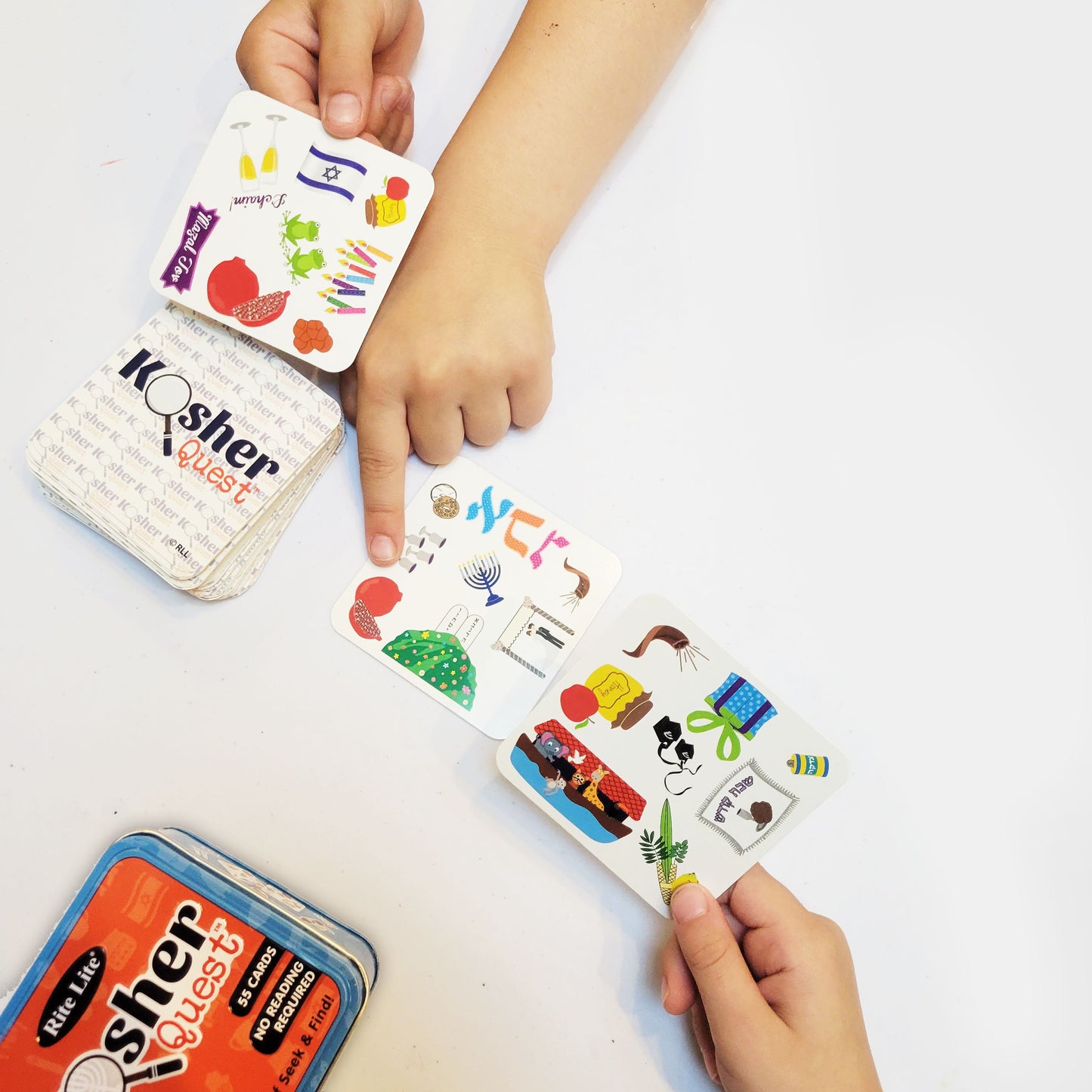 Young child's hands pointing at playing cards