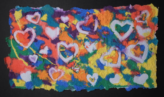 Highly textured handmade paper with various bright colors and embossed white hearts