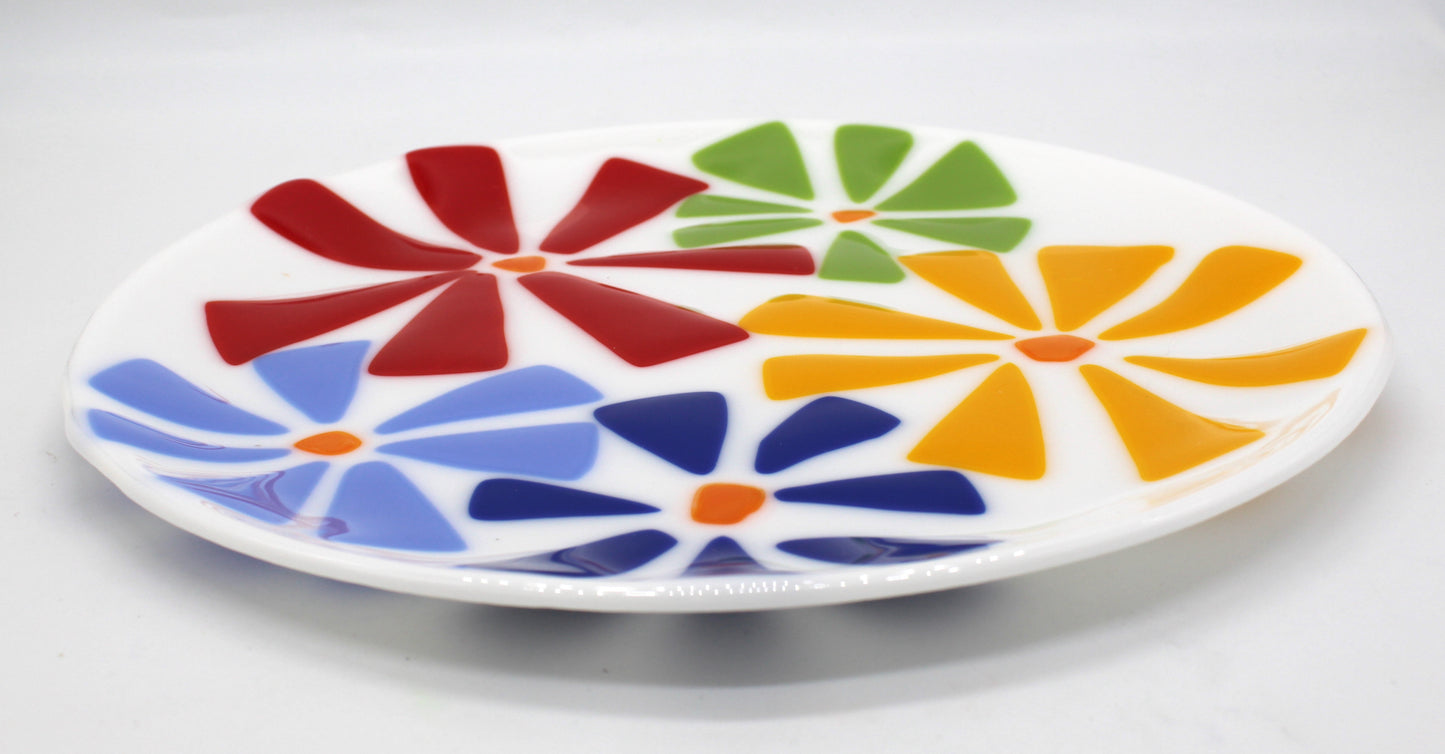 white glass plate with flowers on top