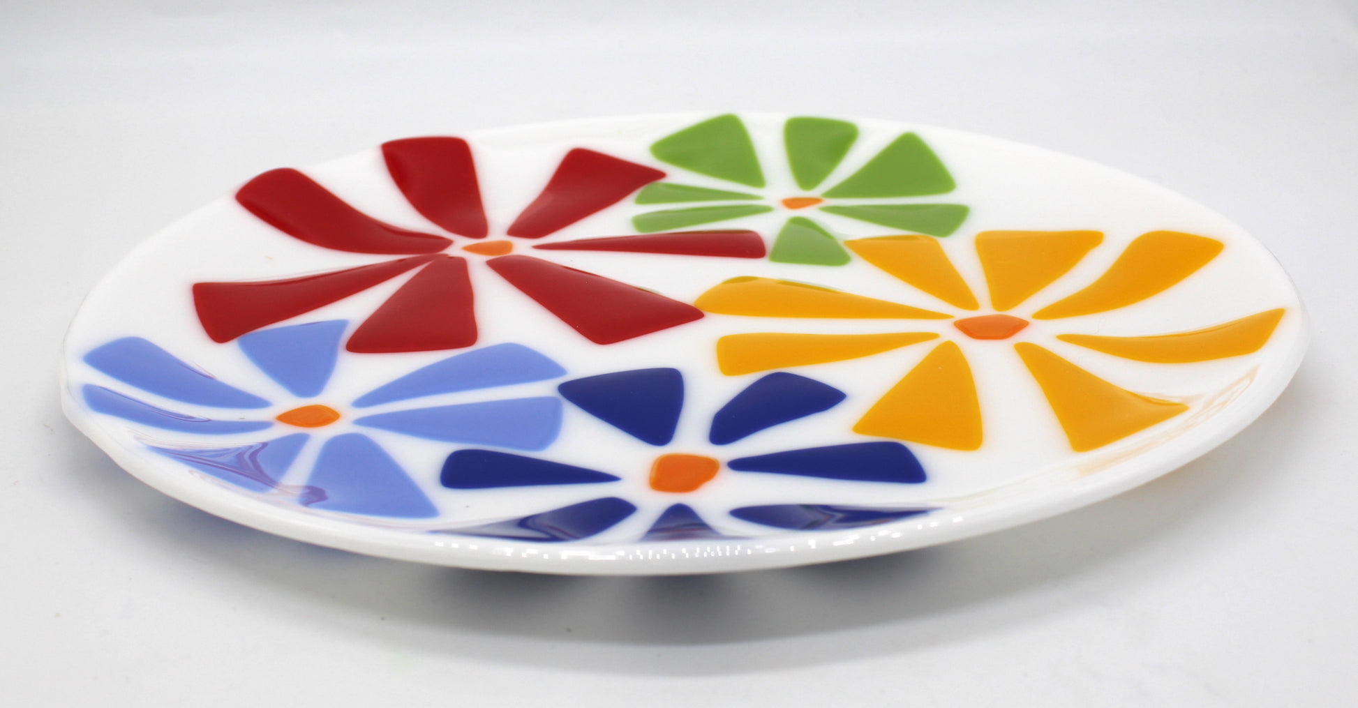 white glass plate with flowers on top