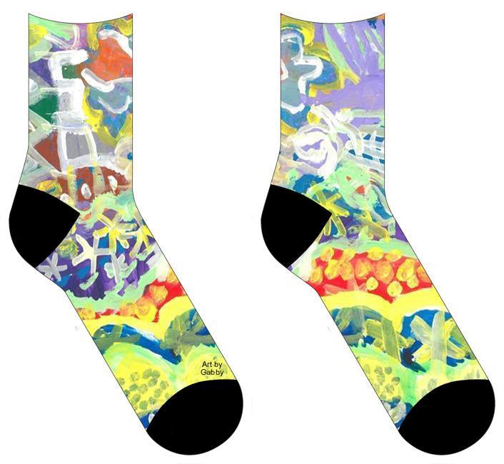 Socks with Painting with various patterns in each section. The background is mostly of purples and blues with curved sections painted with a light green. In between each section a different pattern is painted in either a light yellow or white. Some of the patterns include dots and stars. At the bottom of the painting is an outline of a flower, butterfly, and zigzags.