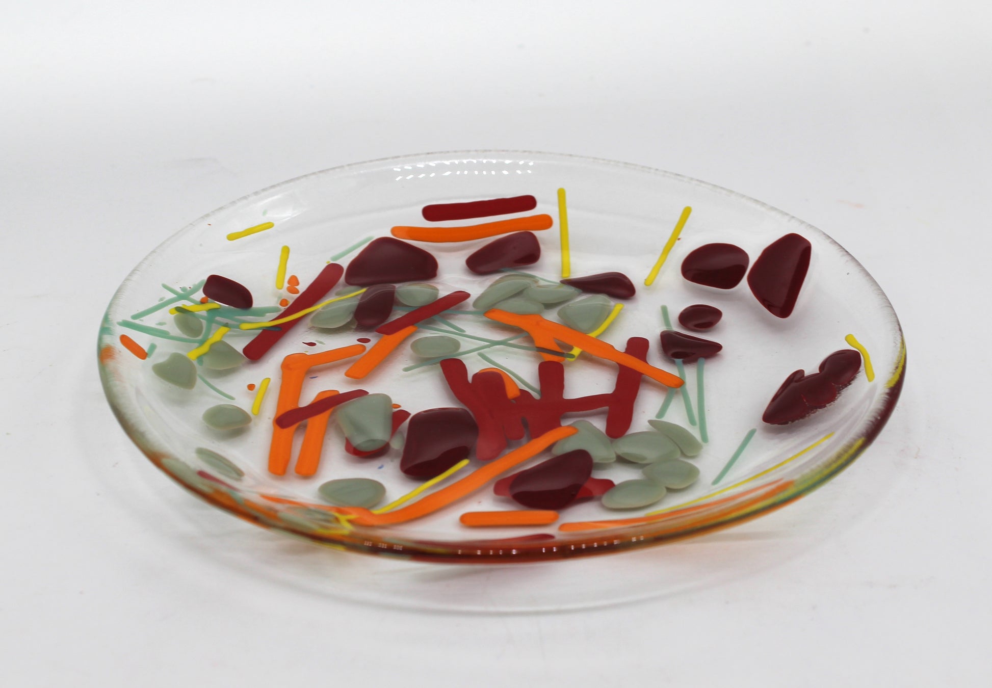 Clear Glass Bowl with lines of yellow, orange, and green & splotches of gray and dark red scattered