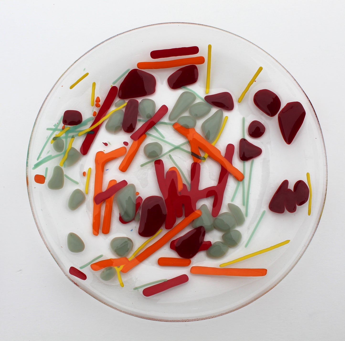 Clear Glass Bowl with lines of yellow, orange, and green & splotches of gray and dark red scattered