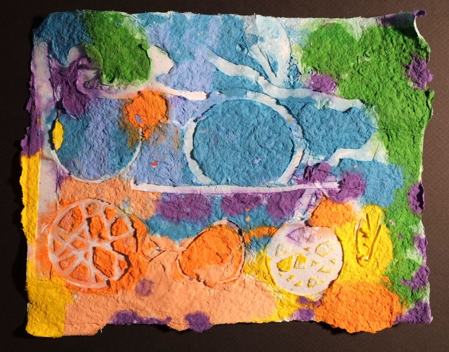 Pigment on recycled paper artwork with blue, orange, green, and purple background and white circles overlaid