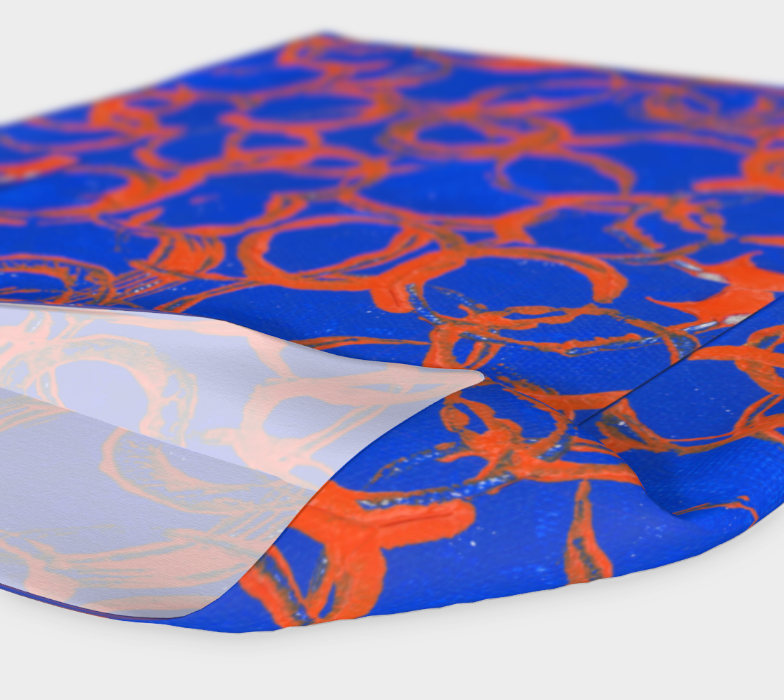 Royal blue scarf with orange overlapping rings of various sizes. Showing inside white.
