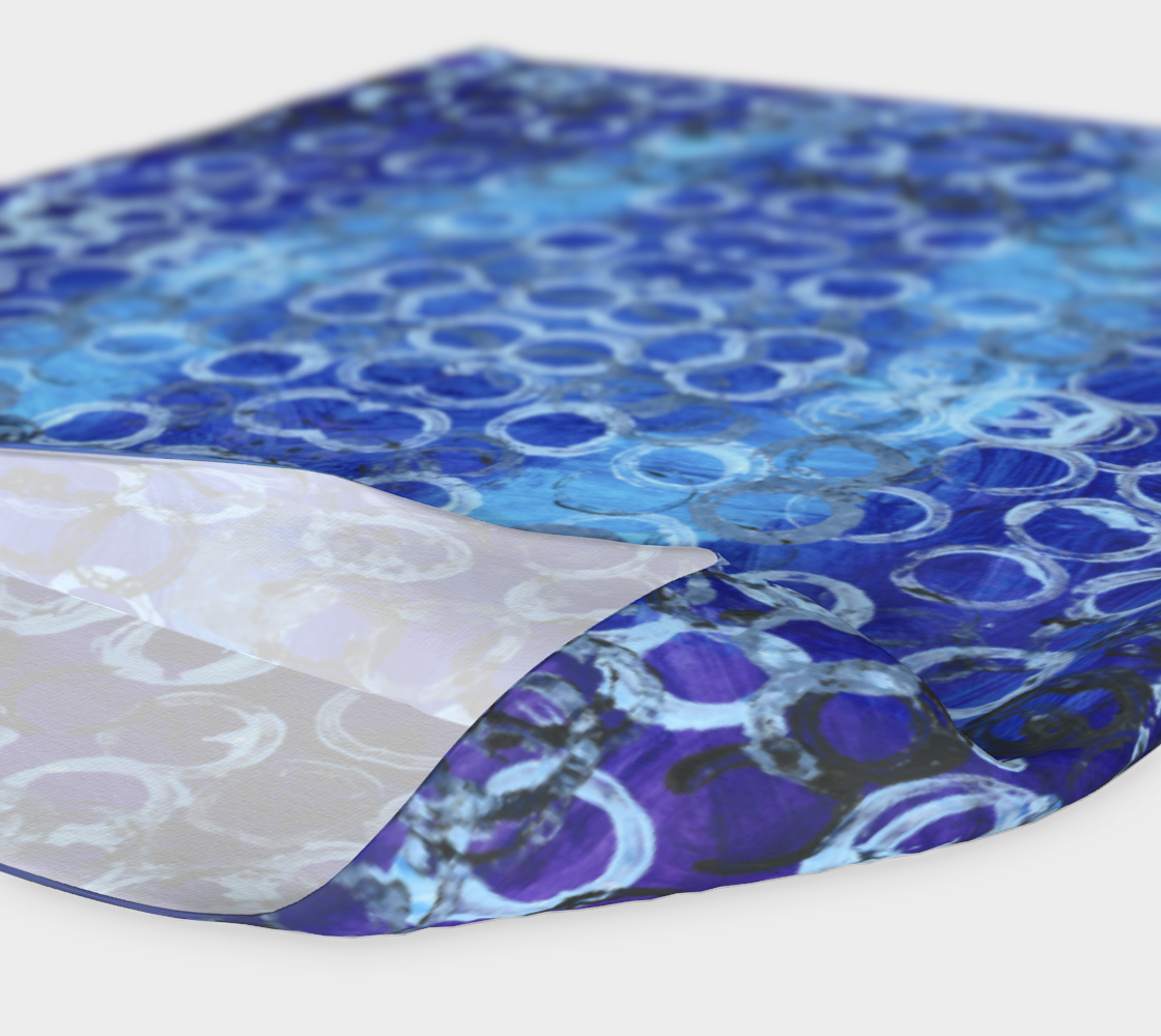 a wide headband of different shades of blue with rings of light and dark blue