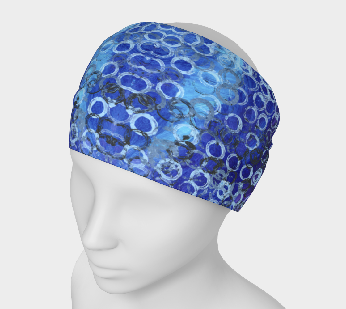Mannequin wearing a wide headband of different shades of blue with rings of light and dark blue