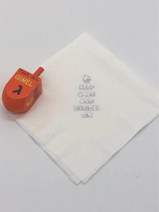 White cocktail napkins with silver dreidel and Keep Calm and Dreidel On slogan