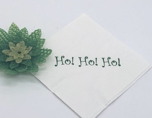 White cocktail napkin with green Ho! Ho! Ho! slogan