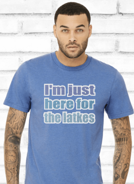 Young adult wearing blue t-shirt with white brick background