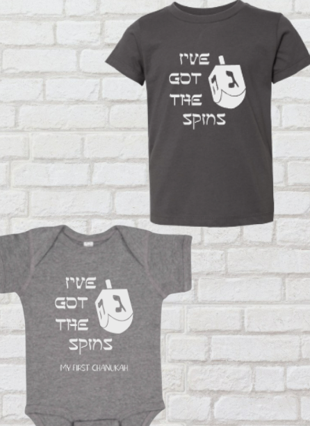 grey t-shirt and grey baby onesie up against a white brick backdrop