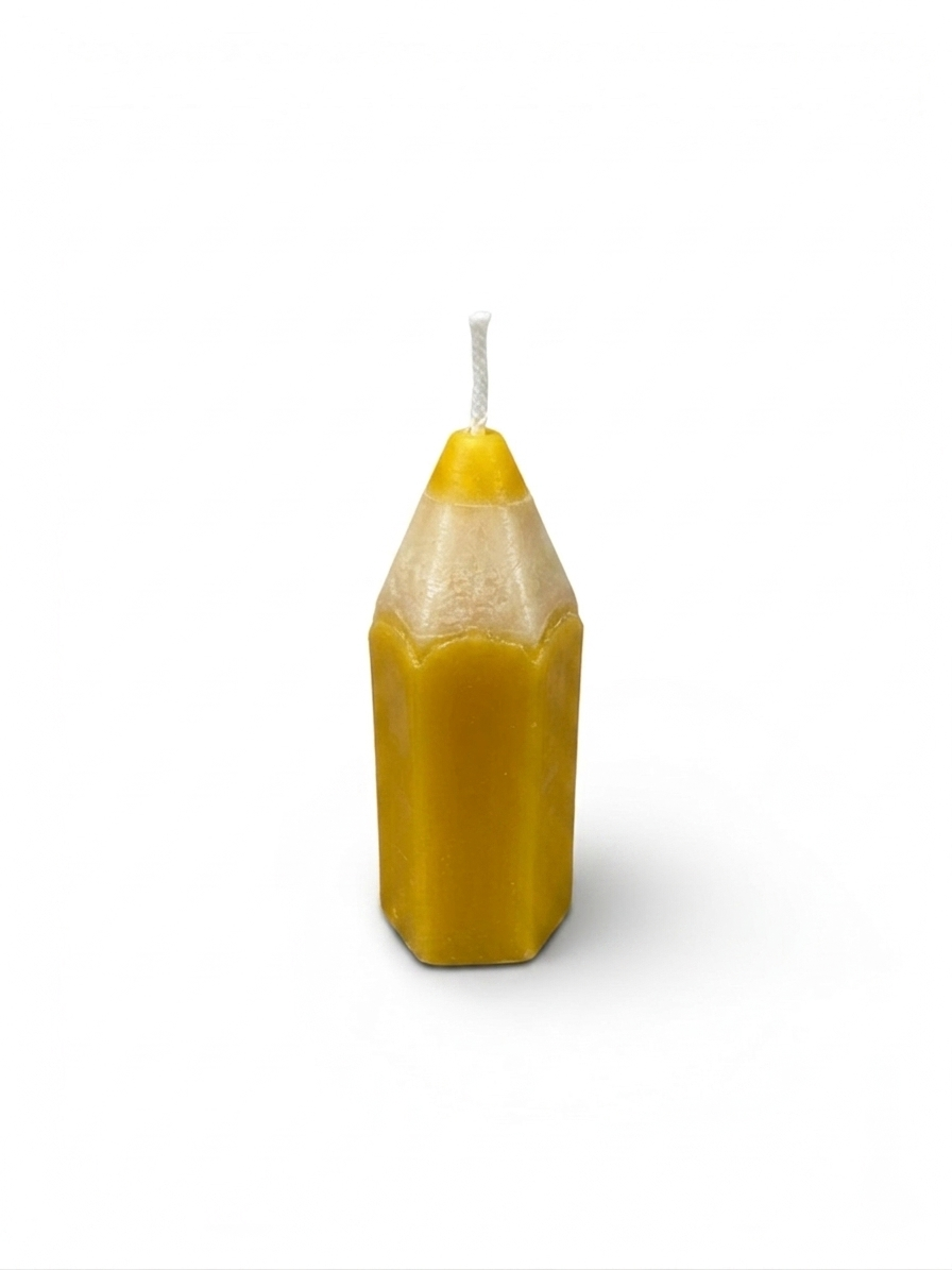 pencil-shaped candles handcrafted by the employees of Celebration Company, featuring a smooth hexagonal texture and a pointed wax tip. (color yellow)