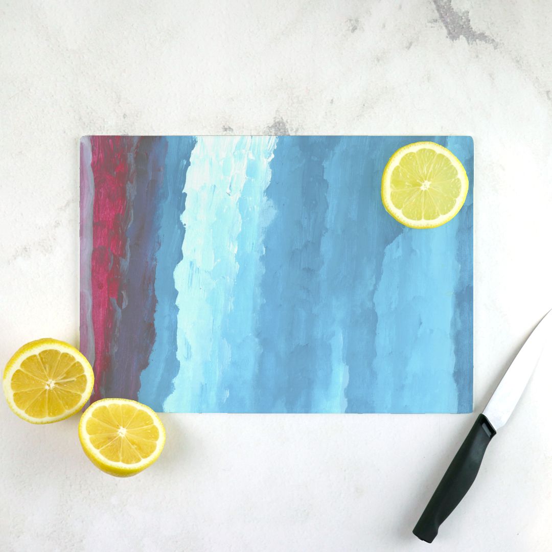 Rectangular glass cutting board with pink, red, dark blue and light blue gradient from left to right