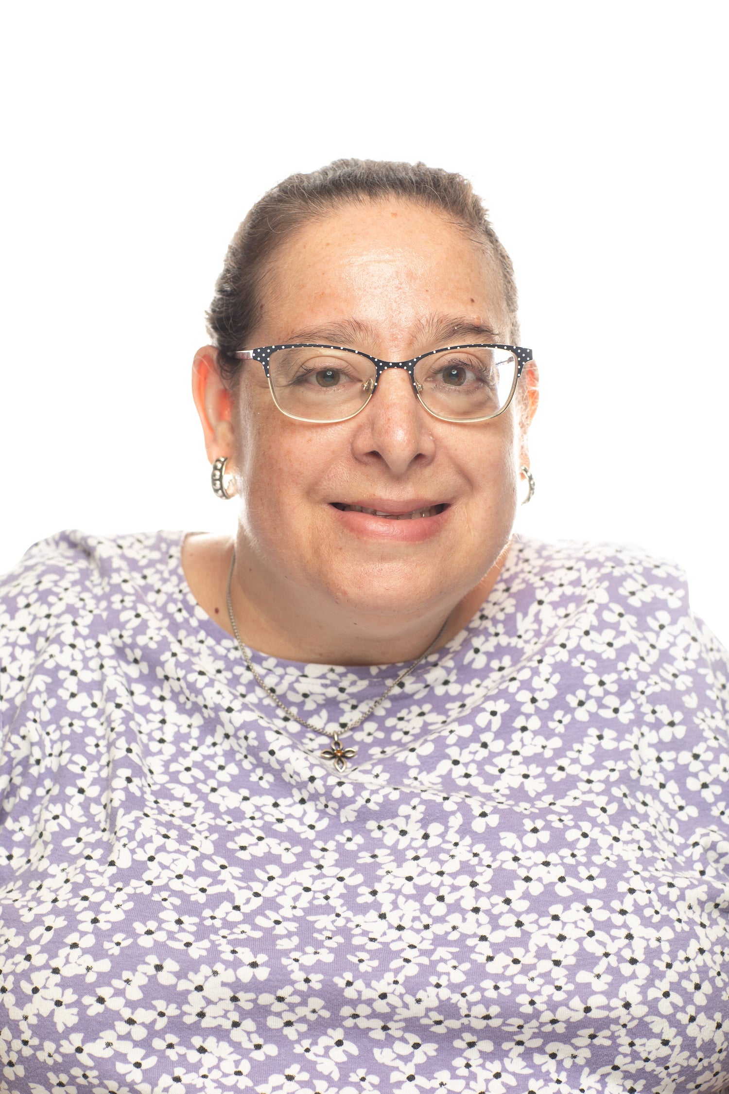 woman wearing glasses and floral shirt smiling