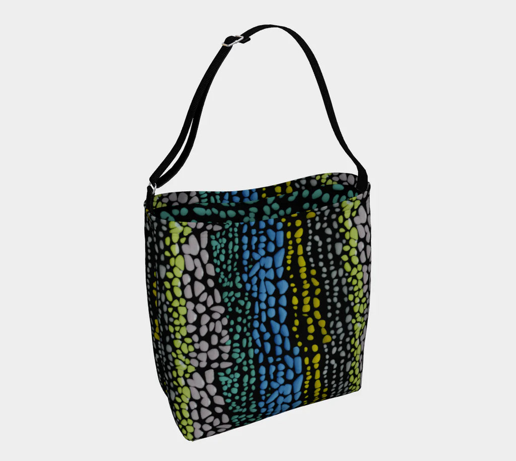 A black tote bag with painted lines of circles of various sizes in yellow, purple, green and blue