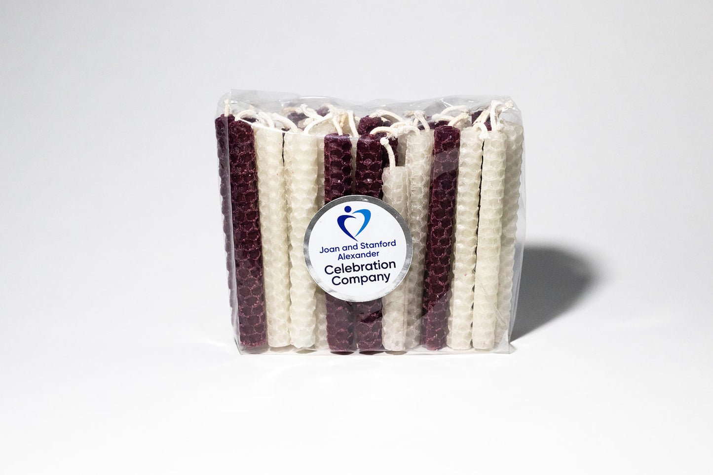 Packages of 44 Chanukah candles in Aggie maroon and white