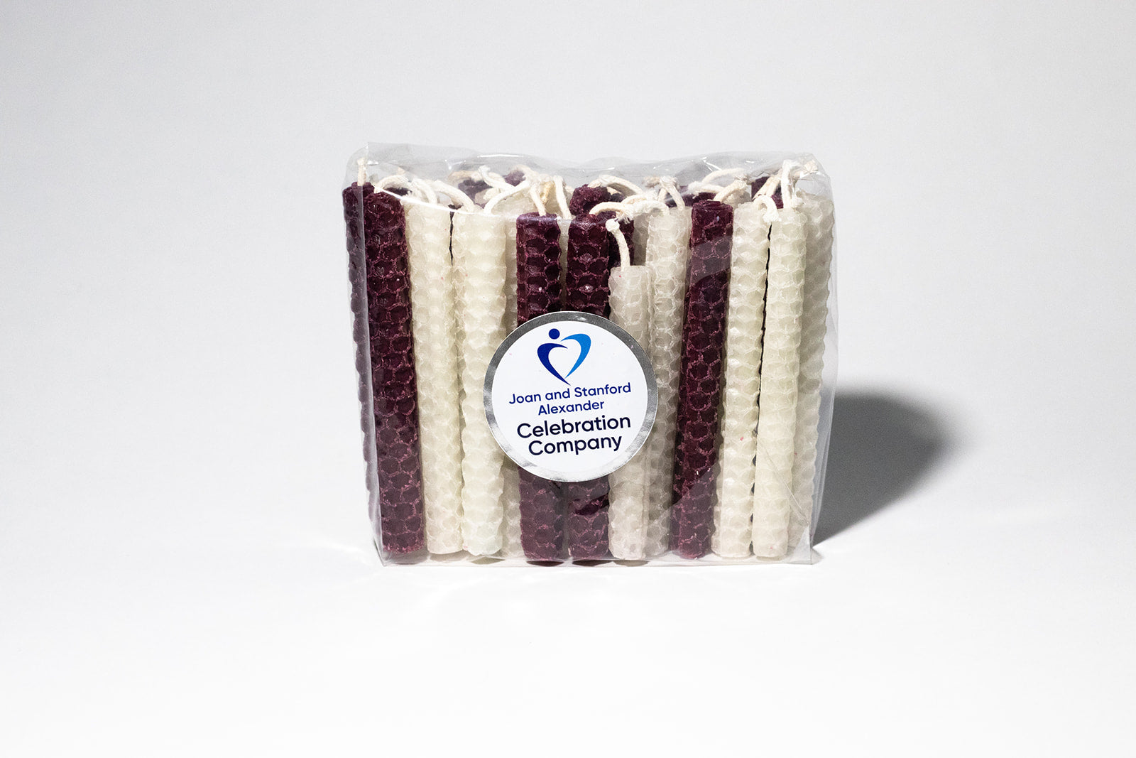 Packages of 44 Chanukah candles in Aggie maroon and white