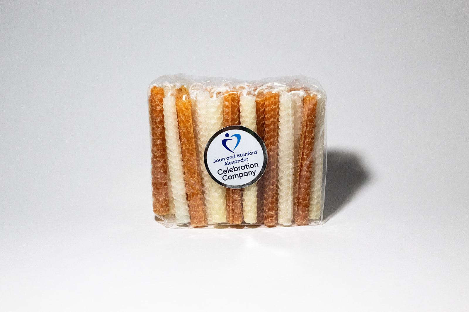 Packages of 44 Chanukah candles in burnt orange and white.