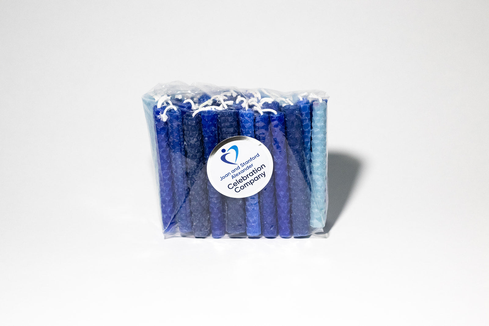  Packaged hand rolled beeswax Chanukah candles with various blue colors