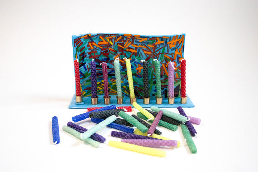 menorah holding a mixture of colored candles