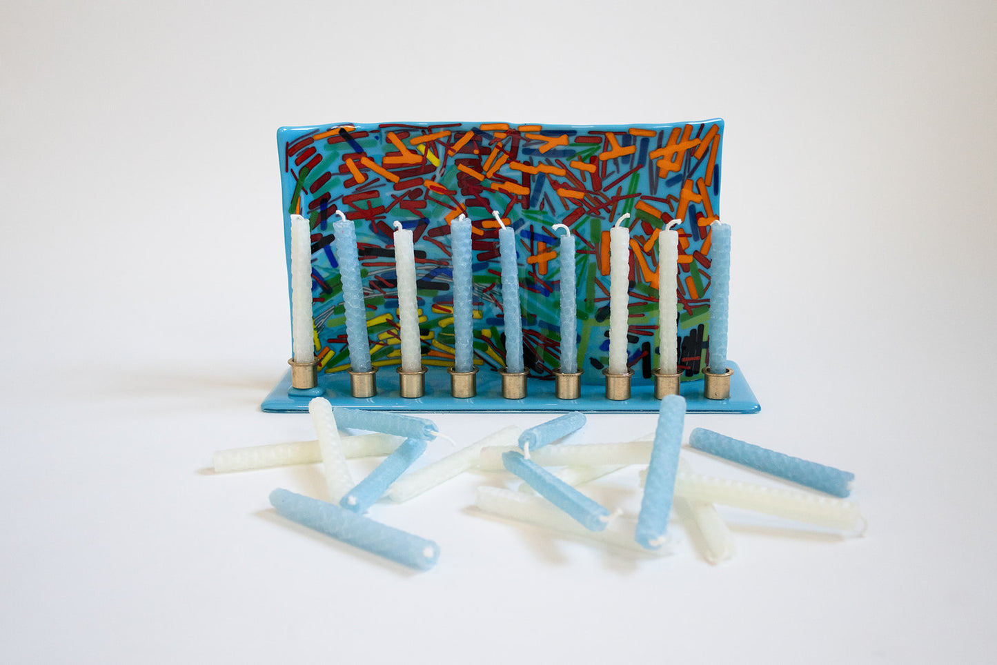 photo of a menorah holding light blue and white candles