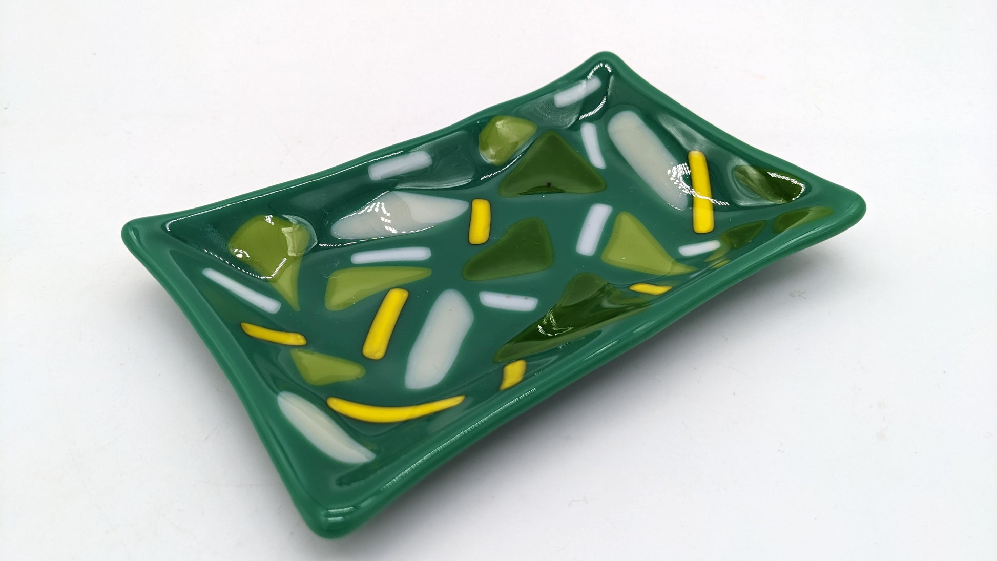 teal soap dish with shades of green with lines of white and yellow