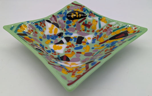 teal glass bowl covered in dots and lines