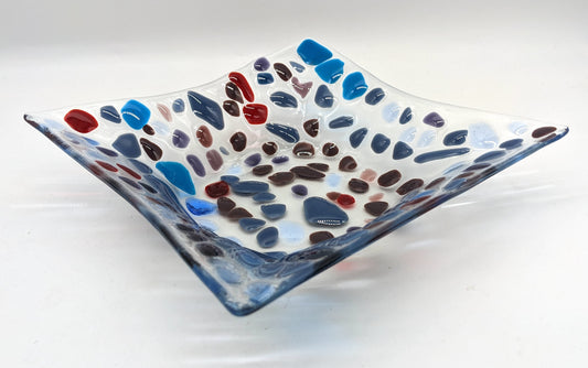 glass bowl with dots of shades of purples, blue, and red