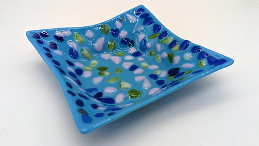 blue glass bowl with dots in rows of blue, purple, and green