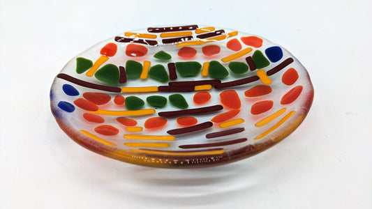 glass plate with orange and red lines with green dots