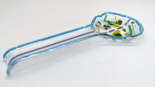 glass spoon rest with green specs in center and blue outline
