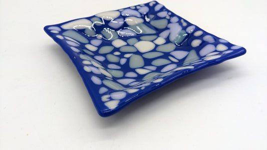 blue glass bowl with dots of gray, white, and light pink