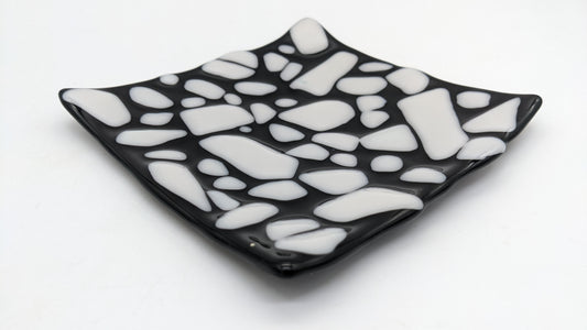 black glass curved plate with white dots