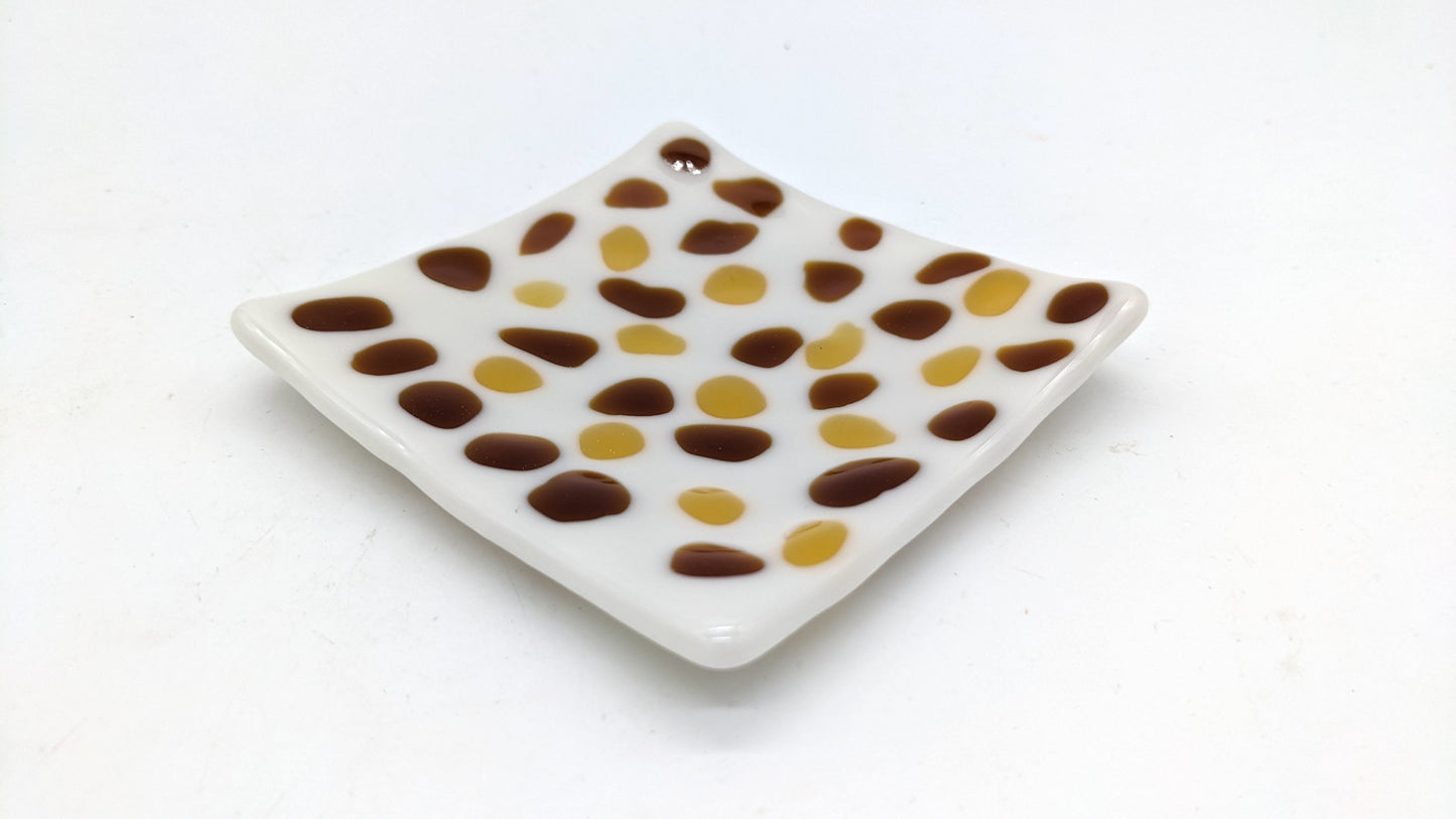 white glass with brown spots