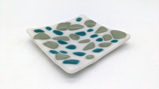 white glass with green and teal dots