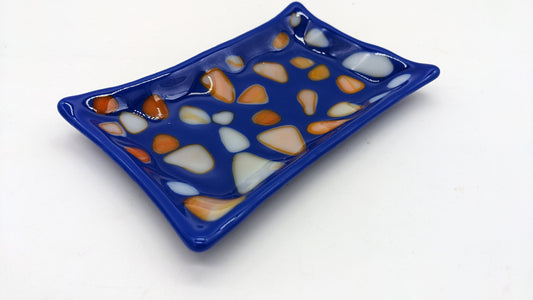 blue glass soap dish with orange and white dots