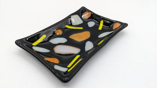 black soap dish with orange and yellow