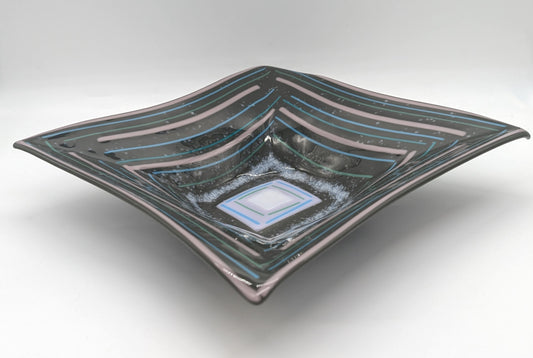 gray square bowl with purple and blue lies alternating outlining the edges of the bowl and shrinking in the center