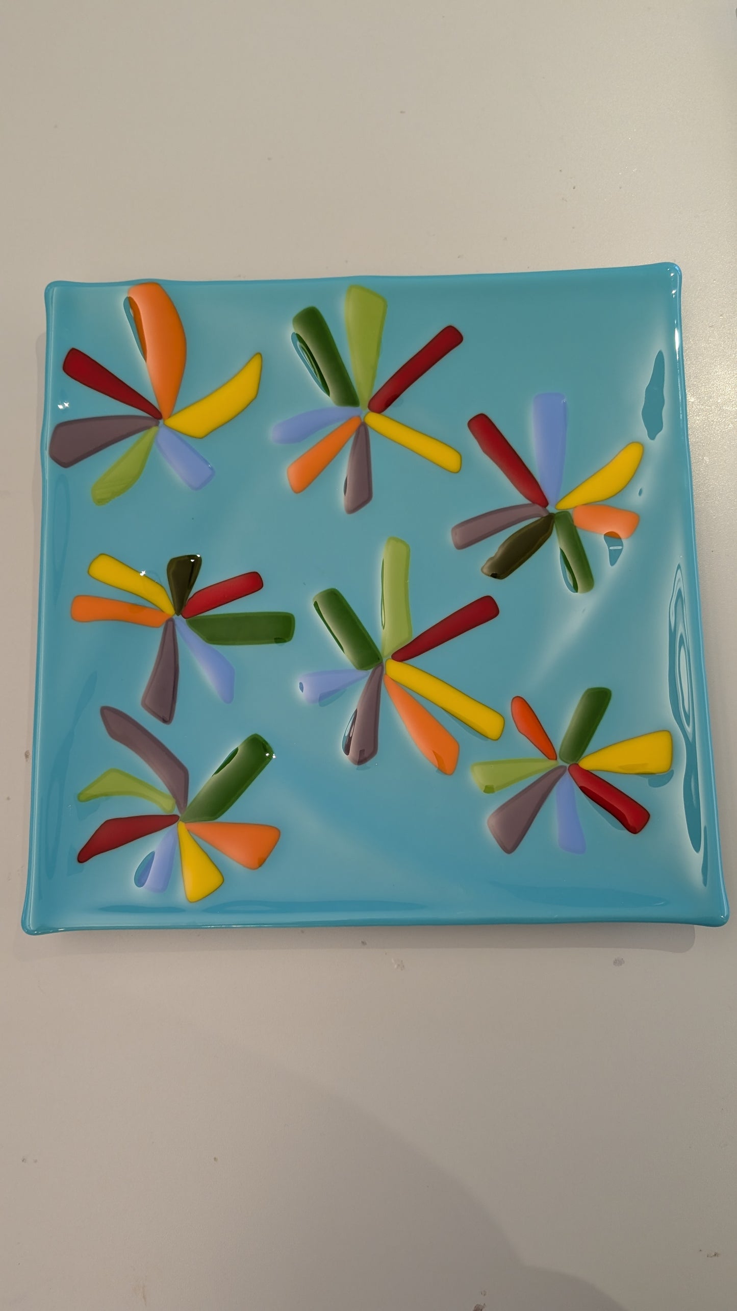 glass plate with colorful flowers on them